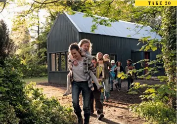  ??  ?? Above: Clare Dunne as single mother Sandra, with her daughters and the volunteer helpers who help her build the house. Left: Director Phyllida Lloyd on set.