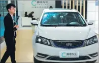  ?? WANG QIMING / FOR CHINA DAILY ?? An electric model by Caocao Zhuanche and Geely is displayed at a new energy exhibition in Nanjing, Jiangsu province.