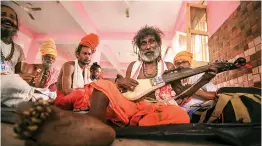  ?? — PTI ?? Sadhus sing religious songs as they wait to register for the Amarnath Yatra, at Ram Mandir Base camp in Jammu on Friday.