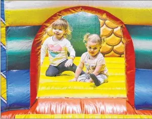  ?? KATIE SMITH/THE GUARDIAN ?? Elise Cormier, 2, of Antigonish, N.S., and Ayla Dewar, 1, of Charlottet­own become new friends in one of the bouncy castles at the Eastlink Centre on Saturday during the Jack Frost Winterfest.