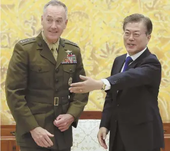  ?? AP PHOTO ?? TAKING STOCK: South Korean President Moon Jae-in, right, greets U.S. Joint Chiefs Chairman Gen. Joseph Dunford yesterday in Seoul. Rising tensions last week between the U.S. and North Korea led to volatile trading in the stock market.