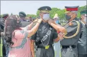  ?? IMA PHOTO ?? Reviewing officer Lt Gen RP Singh, along with his wife, pip stars on the shoulders of a cadet.