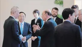  ?? ANDY WONG THE ASSOCIATED PRESS ?? America’s Wilbur Ross, centre, speaks with Chinese Vice-Premier Liu He, left, after a Beijing meeting Sunday.