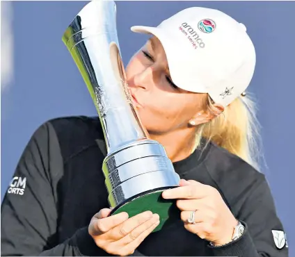  ??  ?? Long wait: Anna Nordqvist kisses the trophy after winning the AIG Women’s Open, edging out Georgia Hall (below)