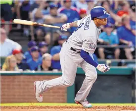  ?? MARK J. TERRILL ASSOCIATED PRESS ?? The Dodgers’ Manny Machado follows through on a two-run single in the third inning of Los Angeles’ victory over Texas on Tuesday night.