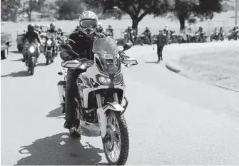  ??  ?? Scott Collins leads a memorial ride Friday near the Saanich intersecti­on where motorcycli­st Rodger Hargreaves collided with a turning truck.