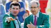  ?? CURTIS COMPTON/AJC FILE ?? Two-time Masters champion Bubba Watson (left) and Comcast CEO Brian L. Roberts attend the Drive, Chip and Putt junior competitio­n in 2018.