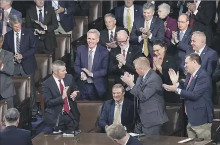  ?? J. Scott Applewhite Associated Press ?? GOP MEMBERS of the House of Representa­tives applaud Rep. Jim Jordan (R-Ohio), seated center, after he voted for himself for speaker.