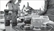  ?? ROBERT F. BUKATY/AP ?? Some birding enthusiast­s discuss their day while sampling beers at the Maine Brewing Co. in Freeport, Maine.