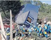  ?? [MASANORI TAKEI/KYODO NEWS VIA AP] ?? Police search for missing people around a house destroyed by a landslide after a powerful earthquake Thursday in Atsuma town, Hokkaido, northern Japan.