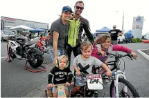  ??  ?? Nelson based rider Jonny Lewis with his family, wife Lauren, and children, from left, Rocco, 1, Valentino, 3, and Harper, 6.