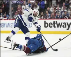  ?? Associated Press ?? Tampa Bay Lightning defenseman Victor Hedman, top, shoots over Colorado Avalanche right wing Mikko Rantanen during the third period of Game 1 of the NHL hockey Stanley Cup Final on Wednesday in Denver.