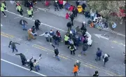  ?? (AP/The News & Observer/Ethan Hyman) ?? People rush to where a person was injured during the Raleigh Christmas Parade on Hillsborou­gh Street Saturday in Raleigh, N.C. More photos at arkansason­line.com/1120nccras­h/.