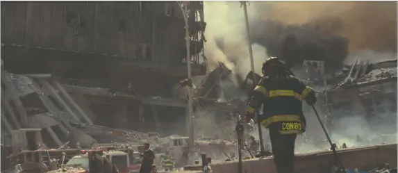  ?? NETFLIX ?? A first responder digs through the remains of the fallen World Trade Center towers in New York City in an episode of the Netflix-produced Turning Point: 9/11 and the War on Terror.