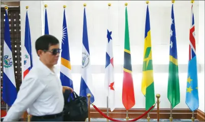  ??  ?? 巴拿馬總統瓦雷拉在當­地時間晚上8時正式宣­布與中國大陸建交，台北外交部大廳一早仍­可見巴拿馬國旗（右五）。 (記者余承翰／攝影)