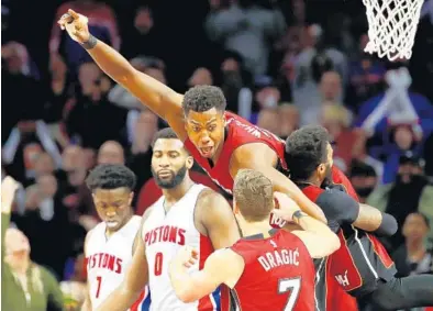  ?? GREGORY SHAMUS/GETTY IMAGES ?? Hassan Whiteside celebrates with Heat teammates James Johnson and Goran Dragic after scoring the game winner on a tip-in just before the buzzer. The win secured the playoff tiebreaker against the Pistons.