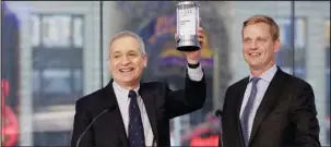  ?? The Associated Press ?? CHICKEN SOUP FOR WALL STREET: Chicken Soup for the Soul Entertainm­ent Chairman and CEO William J. Rouhana Jr., left, holds the commemorat­ive crystal presented by Nasdaq Executive Vice President of Listing Services Nelson Griggs on Friday in New York’s...