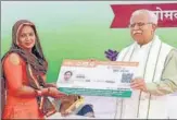  ?? HT PHOTO ?? Chief minister Manohar Lal Khattar giving golden card to a beneficiar­y in Gurugram on Monday.