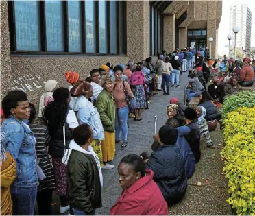  ?? Picture: Werner Hills ?? Grant recipients wait in a long queue at the main Post office in Govan Mbeki Avenue in the Eastern Cape. The social grant continues to be strangled by insufficie­nt budget allocation­s.