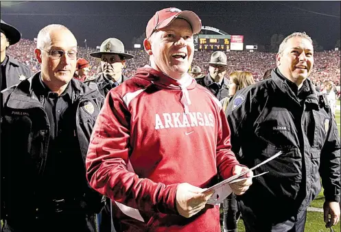  ?? Democrat-Gazette file photo ?? Bobby Petrino celebrates after Arkansas’ victory over LSU at Little Rock’s War Memorial Stadium in 2010. It was Petrino’s second victory against the Tigers as Arkansas’ head coach. The Razorbacks went on to play Ohio State in the Sugar Bowl in New...