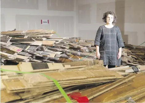  ?? BRANDON HARDER ?? Jackie Schmidt, president of Heritage Regina, stands among some of the materials that will be included in an auction being put on by Heritage Regina. Many of the items are architectu­ral salvage removed from the College Avenue Campus of the University of Regina.