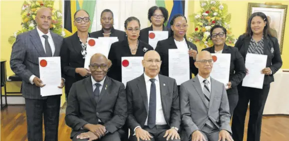  ?? (Photo: JIS) ?? Governor-general Sir Patrick Allen (seated centre); Chief Justice, Bryan Sykes (seated left); and president of the Court of Appeal Justice Patrick Brooks (seated right), with members of the judiciary who were appointed to act in higher offices for the Easter Term, at Wednesday’s swearing-in ceremony, held at King’s House.