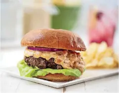  ?? CHEYENNE COHEN/AP] [PHOTO BY ?? This burger with pimento cheese is from a recipe by Katie Workman.