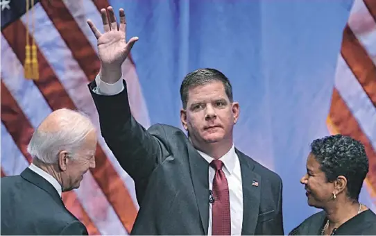  ?? STAFF PHOTO BY NANCY LANE ?? ‘A MAN OF EXTRAORDIN­ARY CHARACTER’: Mayor Martin J. Walsh waves to the crowd after being sworn in during his inaugurati­on at the Cutler Majestic Theatre in Boston yesterday.