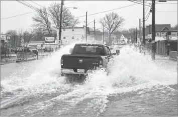  ?? DAVID JALA/CAPE BRETON POST ?? Flood conditions may have forced many motorists to find alternativ­e routes around Sydney, but this pick-up truck seemed to have no problem splashing its way down Townsend Street. The area around the railway tracks and the Wash Brook is one of the first sections of the municipali­ty to flood when heavy rains hit Cape Breton.