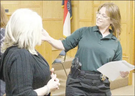 ?? Daniel Bereznicki/McDonald County Press ?? Detective Lorie Howard (right) embraces Danielle Pixler of Topeka, Kan., before a press conference on March 21 in which Howard and other investigat­ors announced the solving of Pixler’s sister’s murder, a 30-year-old cold case. Shauna Garber was killed in 1990 by Talfey Reeves, investigat­ors said.