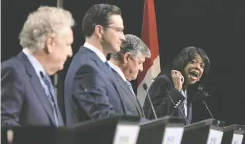  ?? — ADRIAN WYLD/THE CANADIAN PRESS ?? Conservati­ve leadership candidate Leslyn Lewis launches a broadside at Pierre Poilievre, second from left, as Jean Charest and Scott Aitchison look on during a debate in Ottawa on Thursday.