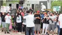  ?? WOOD/MILWAUKEE JOURNAL SENTINEL RICK ?? Joel Acevedo’s parents hug as family members gather for a protest outside the home of Michael Mattioli, a Milwaukee police officer charged with reckless homicide in Acevedo’s death.