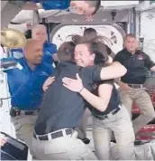  ?? NASA ?? Newly arrived astronauts from a SpaceX capsule are greeted by the astronauts from the Internatio­nal Space Station on Saturday after the Dragon capsule docked.