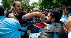  ?? Reuters ?? BLACK DAY: Police try to stop protesters of the All Parties Hurriyat Conference during a rally near the Indian High Commission in Islamabad. —