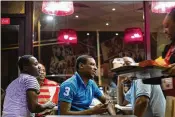  ??  ?? Daniel Awaitey (center) celebrates his birthday with friends at KFC in the East Legon neighborho­od of Accra, Ghana, on July 25. “When I grew up I did not have the benefits I’m enjoying today,” Awaitey said.