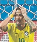  ?? JEWEL SAMAD/AFP/GETTY IMAGES ?? Brazil's brilliant Neymar shows his suffering as his side falls to Belgium in their World Cup quarter-final.