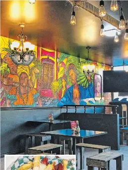 ?? DIANE GALAMBOS PHOTO ?? A mural painted by Julio Morales portrays representa­tions of South America that, along with vintage lighting, create a rustic vibe.