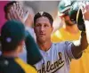  ?? Jayne Kamin-Oncea / Getty Images ?? A’s catcher Yan Gomes is greeted after a home run Saturday in Anaheim.