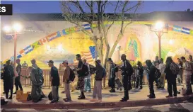  ?? JAE C. HONG ASSOCIATED PRESS ?? Homeless people wait in line for a meal served by a community organizati­on outside Our Lady Queen of Angels Catholic Church on Sept. 21, 2017, in Los Angeles. An unpreceden­ted homeless crisis is rocking the West Coast.