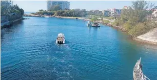  ?? JOE CAVARETTA/STAFF PHOTOGRAPH­ER ?? Dredging equipment is in the Boca Inlet. Sand is being taken from the channel and spread along the beach.