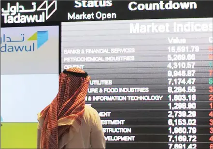  ?? (AFP) ?? An investor monitors shares at the Saudi Stock Exchange in Riyadh. The Tadawul has been upgraded to the status of an emerging market by global index
provider MSCI, a step expected to lure billions of dollars in foreign investment­s.