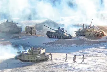  ?? Photo — AFP ?? Undated handout photograph released by the Indian Army shows People Liberation Army (PLA) soldiers and tanks during military disengagem­ent along the Line of Actual Control (LAC) at the India-China border in Ladakh.