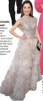  ??  ?? Michelle Yeoh Golding’s “Crazy Rich Asians” co-star looked stunning in a gold Elie Saab gown that combined sequins and feathers.