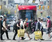  ?? PETER KUITENBROU­WER / FINANCIAL POST FILES ?? Residents of urban areas like Toronto are more likely to be miserable with their lot, a study of surveys shows.