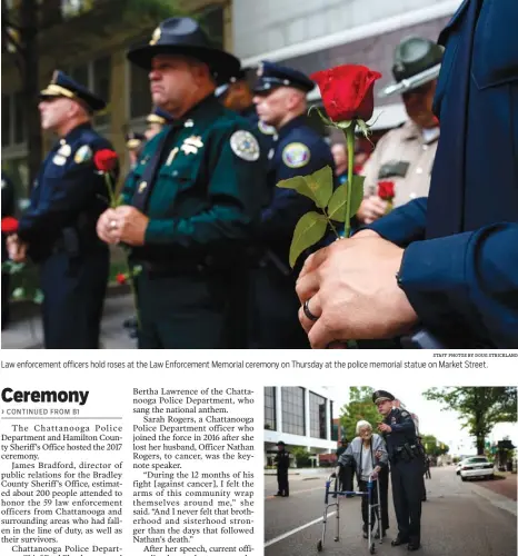  ?? STAFF PHOTOS BY DOUG STRICKLAND ?? Law enforcemen­t officers hold roses at the Law Enforcemen­t Memorial ceremony on Thursday at the police memorial statue on Market Street. Chattanoog­a police Lt. Danny Jones helps Lillian Wilson, mother-in-law of deceased Hamilton County Park Ranger...