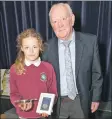  ??  ?? Jock Kelso presents P7 winner Daisy McNamara with her award and medal.