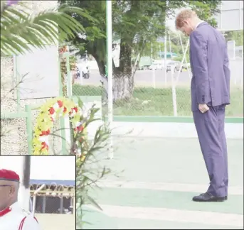  ??  ?? Prince Harry paying his respects at the Independen­ce Arch yesterday afternoon during his two-day visit to Guyana as part of his Caribbean tour.