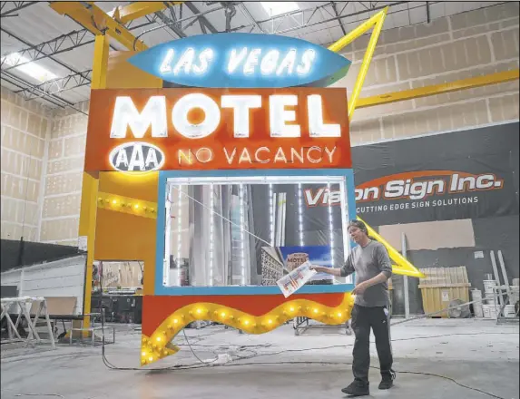  ?? Erik Verduzco Las Vegas Review-Journal @Erik_Verduzco ?? Las Vegas City Attorney Brad Jerbic looks at a Las Vegas Motel sign being restored at the Vision Sign headquarte­rs.