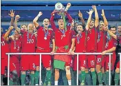  ??  ?? Cristiano Ronaldo lifts the trophy after Portugal beat France in the Euro 2016 final at the Stade de France in Paris.