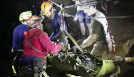  ?? THAI NAVYSEAL FACEBOOK PAGE VIA AP ?? Rescuers hold an evacuated boy inside the Tham Luang Nang Non cave in Mae Sai, Chiang Rai province, in northern Thailand. A daring rescue mission in the treacherou­s confines of a flooded cave in northern Thailand has saved all 12 boys and their soccer coach who were trapped deep within the labyrinth, ending a grueling 18-day ordeal that claimed the life of an experience­d volunteer diver and riveted people around the world.